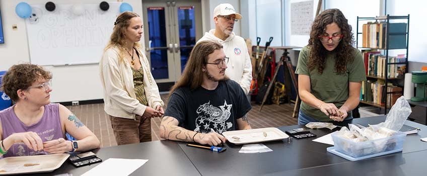 students and professor working in new Archaeology Lab
