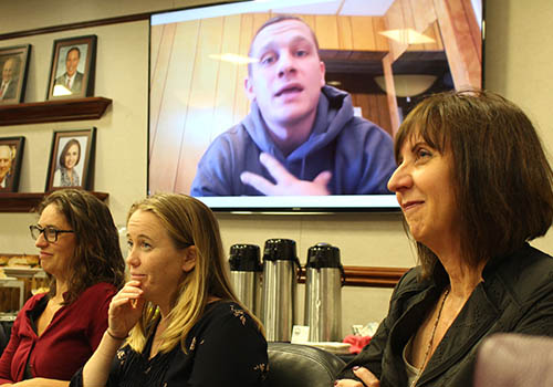 Man speaking on screen 