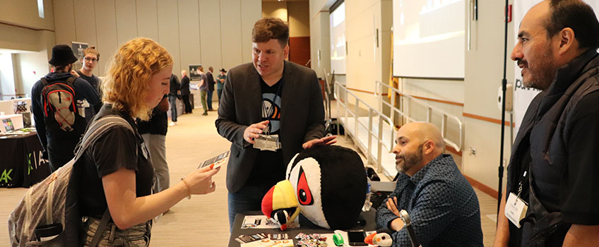 A student talking to a vendor at the third annual Cannabis Fair and Business Expo.