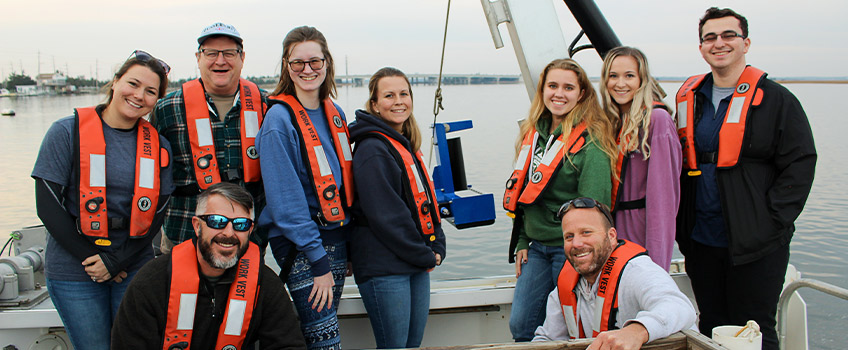 Students, staff in front of the sonar equipment