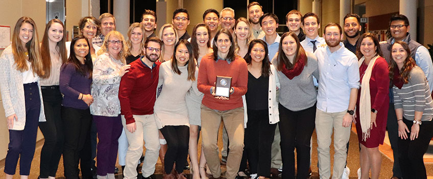 Associate Professor of Physical Therapy Lauren DelRossi, center, receives the Faculty Member of the Year Award.