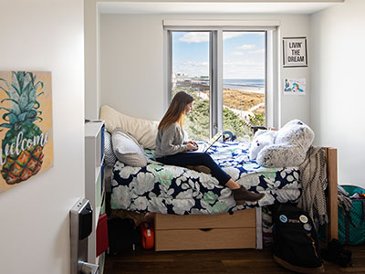 Student sitting on bed