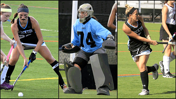 girl playing field hockey