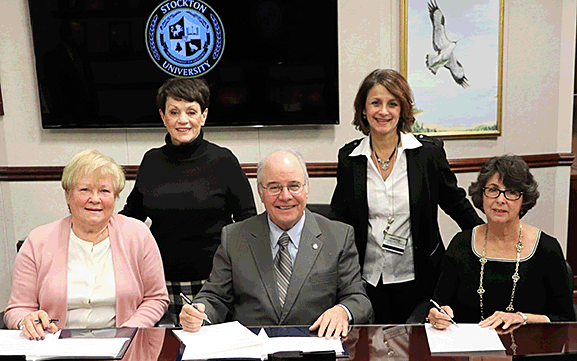 From left, Ronnie Bacharach, widow of the late Howard Bacharach; Maureen English, vice president of the Howard Bacharach Scholarship Foundation; Stockton University President Harvey Kesselman; Donna Albano, associate professor of Hospitality and Tourism Management Studies; and Johanna Johnson, chair of the Stockton University Foundation, attended a brief signing ceremony Dec. 17, to formally establish an endowed scholarship for hospitality, tourism and culinary students at Stockton University.