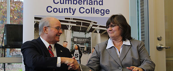 Stockton president Harvey Kesselman and Cumberland County College Interim President Shelly Schneider sign the agreement at Cumberland County College in Vineland.