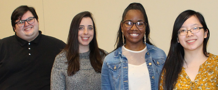 Four students smiling