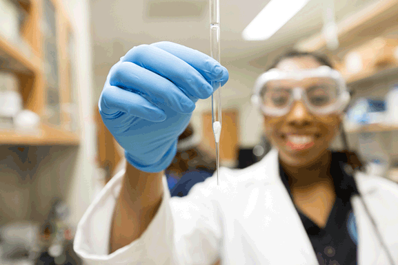 girl holding test tube