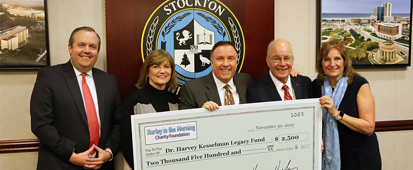 Margie and Harry Hurley, second and third from left, present a $2,500 check to establish the Dr. Harvey Kesselman Legacy Fund Scholarship. At left is Dan Nugent, the vice president for University Advancement and executive director of the University Foundation. At right is Stockton President Dr. Harvey Kesselman and First Lady Lynne Kesselman.