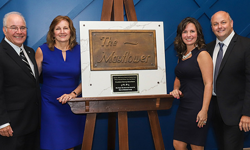 President Harvey Kesselman, Lynne Kesselman, and Don and Michelle Purdy with the sign