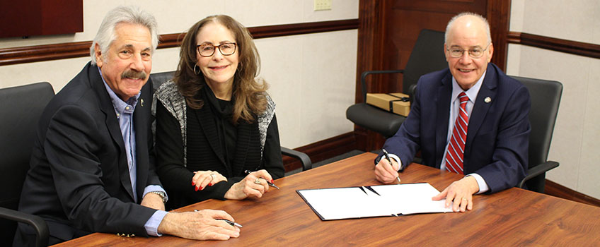 Stuart and Rita Stromfeld sign an agreement establishing the Helen and Murray Fassler Memorial Endowed Holocaust Studies Scholarship with President Harvey Kesselman