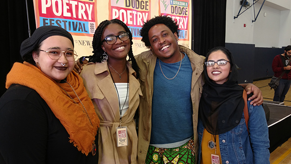 three women and a man smiling