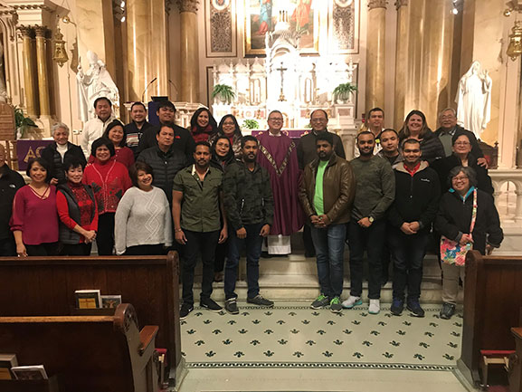 group of men and women standing in church