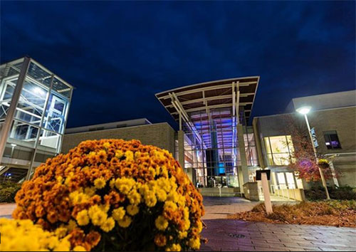 mums infront of campus center at night