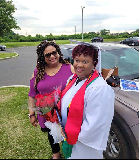 Michelle-Anne Spring and Damaris Spring, who is wearing a silver graduation cap and gown