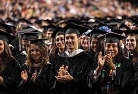 A group of graduates in black caps and gowns