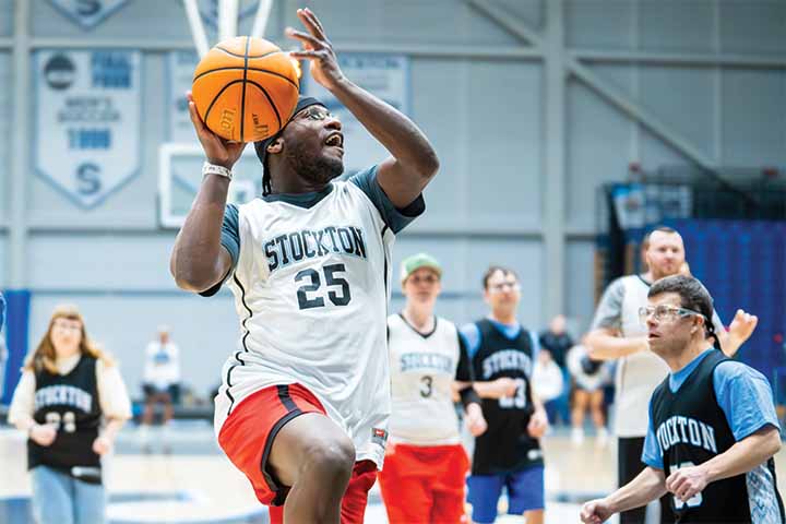 A basketball player sets up for a layup shot in the Sports Center