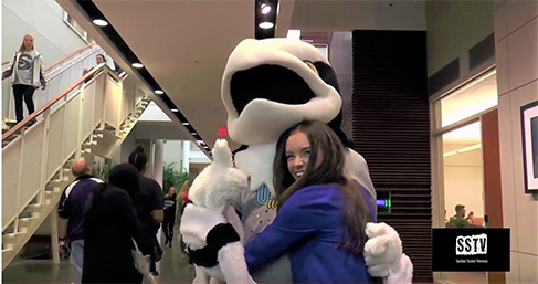 Student reporter with school mascot