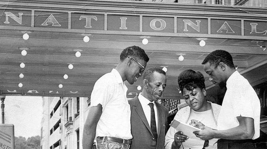 Fannie Lou Hamer talking with colleagues outside of the National Theater in Washington, D.C., on June 16, 1964. 